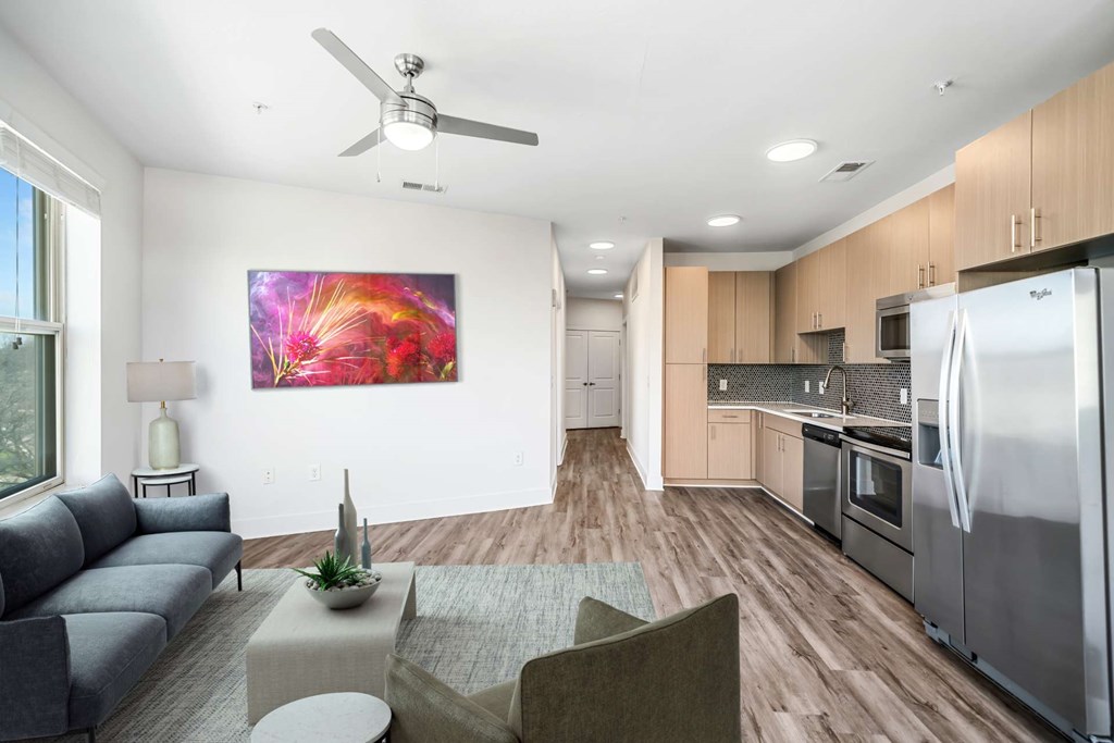 A modern kitchen with a refrigerator, oven, and microwave.