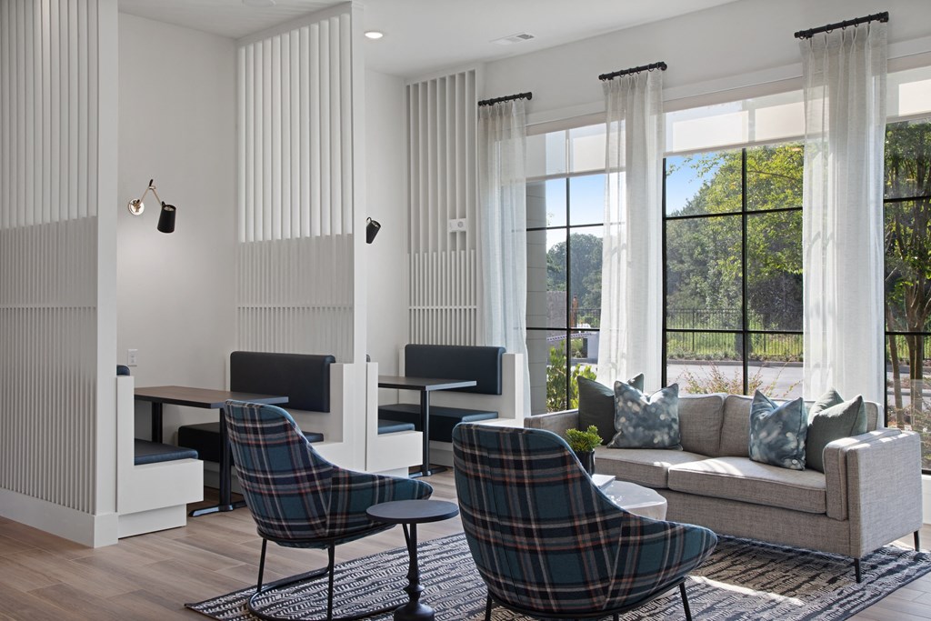 a living room filled with furniture and a large window