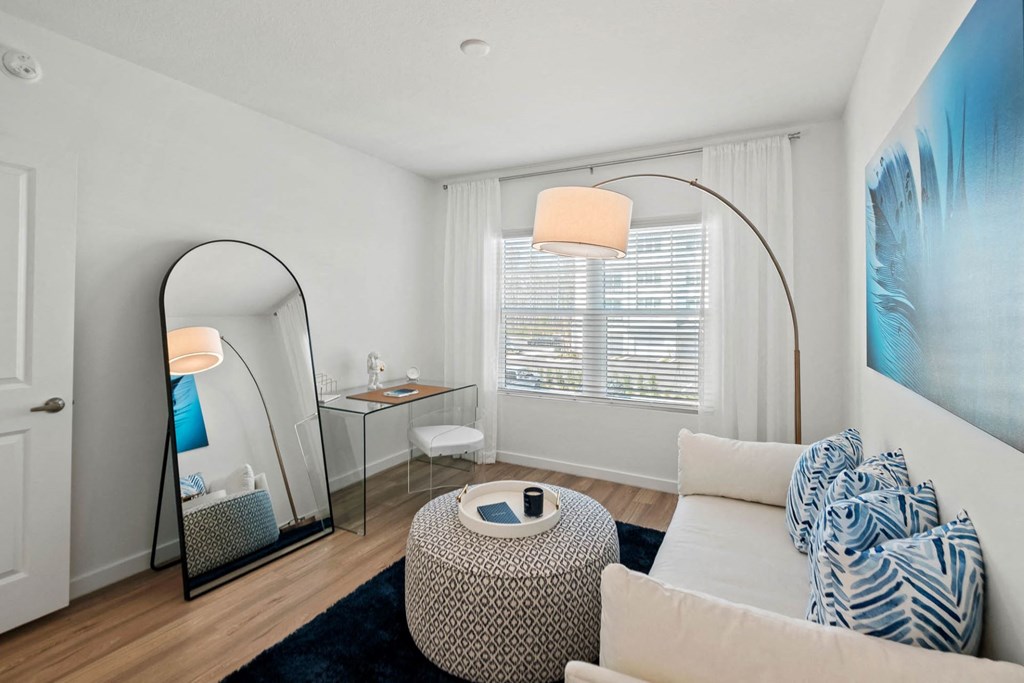 a living room with a couch and a mirror at Altis Twin Lakes Apartments, Florida, 34744