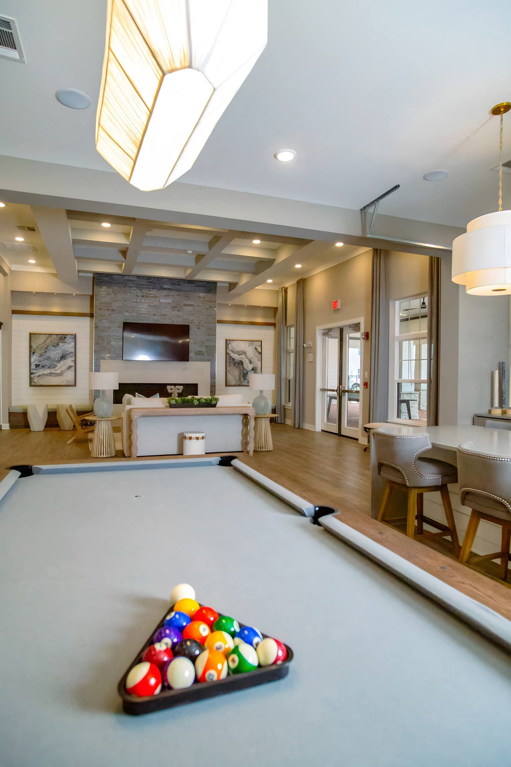 a pool table with billiard balls on it in a living room