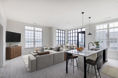 a living room with a kitchen and a couch and a table