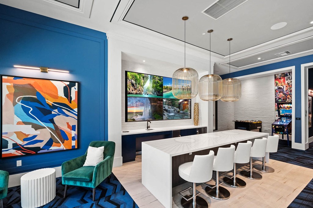 a dining room with blue walls and a white table and chairs