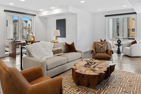 A living room with a brown leather chair and a wooden coffee table.