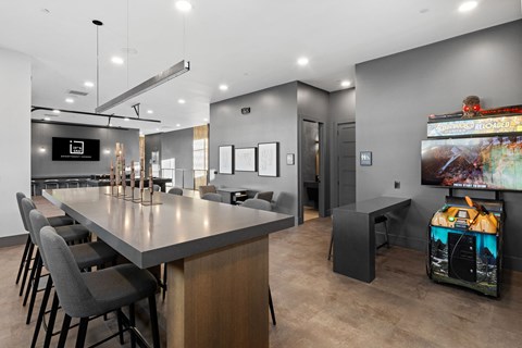 A modern dining area with a long table and chairs.