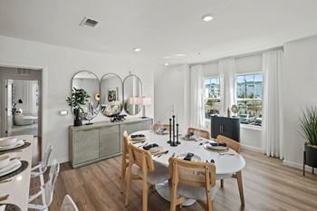 A dining room with a table set for a meal