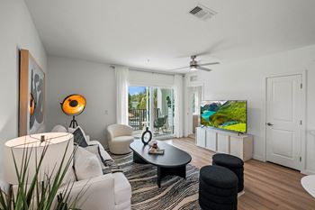 a view of a lobby with white walls and chairs and a glass table at Altis Twin Lakes Apartments, Kissimmee, FL
