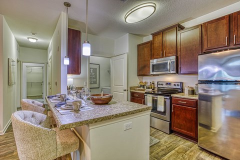 a kitchen with stainless steel appliances and a granite counter top