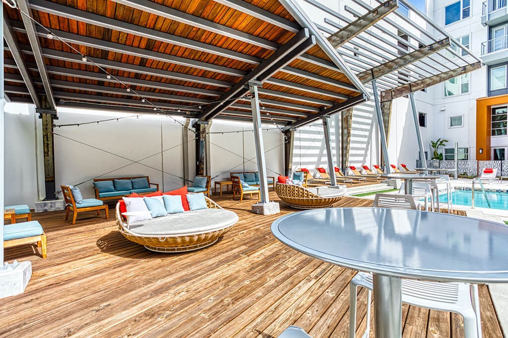 Apartments in Maitland, FL for Rent - The Parker at Maitland Station - Shaded Poolside Lounge Area with Comfortable Seating.