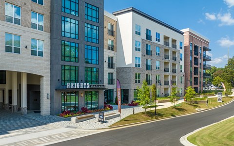 a large apartment building with a street in front of it