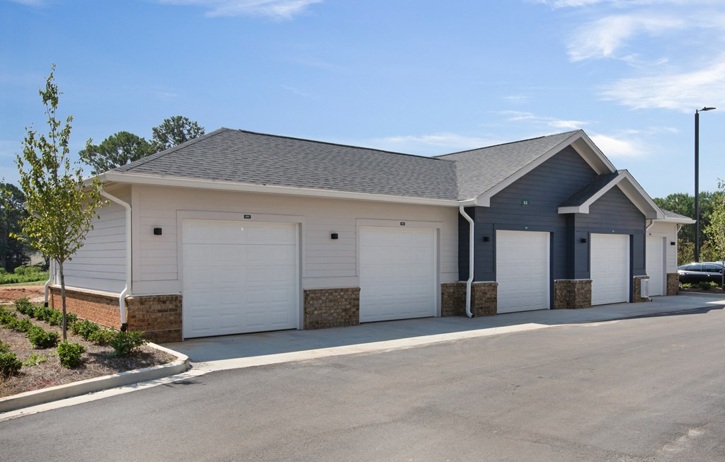 a house with two garages and a parking lot