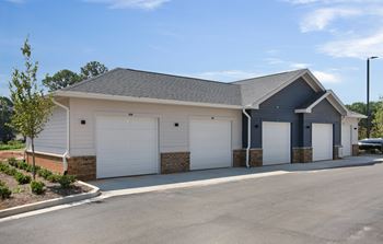 a house with two garages and a parking lot