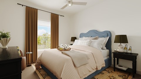 A bedroom with a large bed and a ceiling fan.