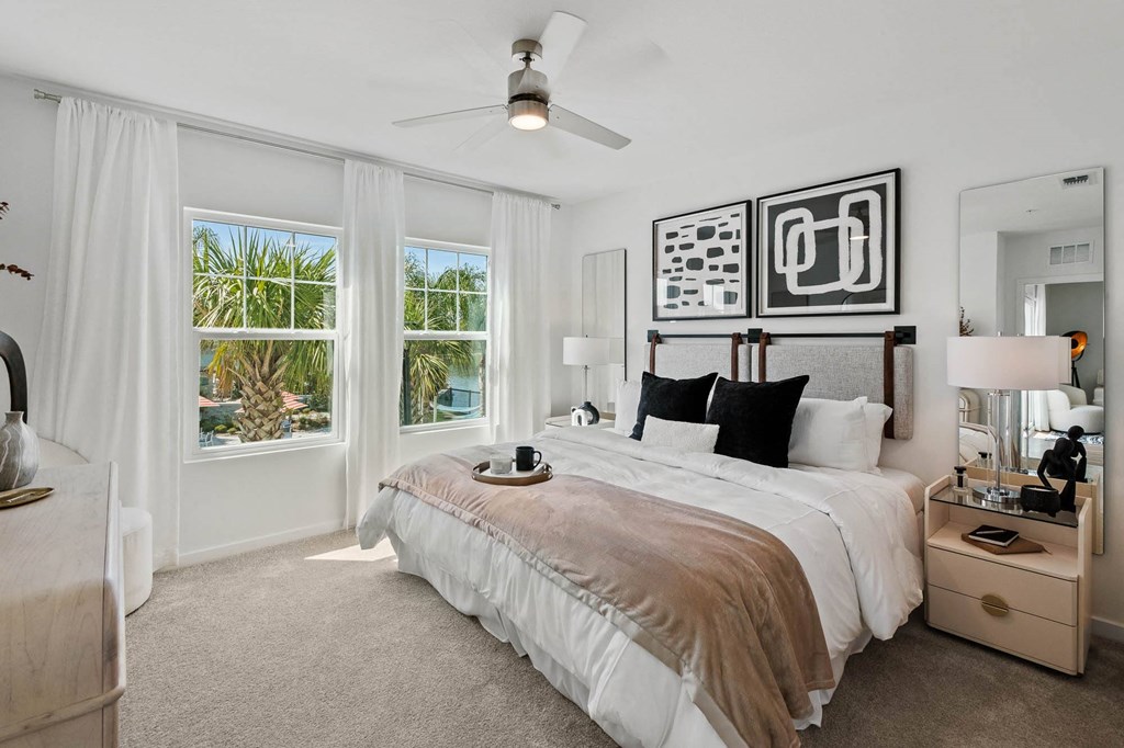 a bedroom with a bed and a ceiling fan