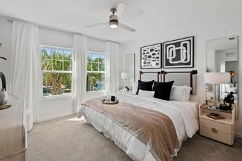 a bedroom with a bed and a ceiling fan at Altis Twin Lakes Apartments, Kissimmee, FL