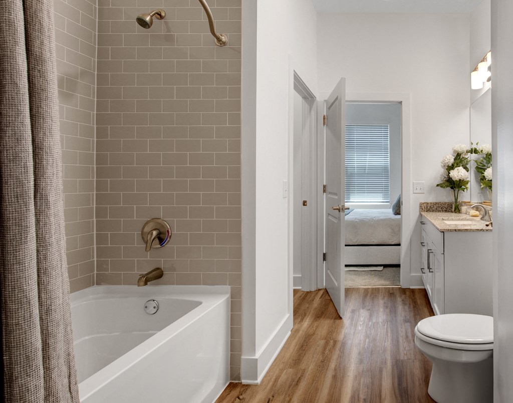 a bathroom with a bathtub and a toilet in a 555 waverly unit