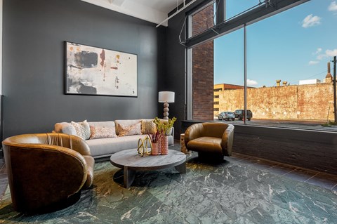 a living room with black walls and a large window