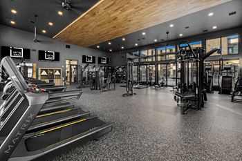 A gym with treadmills and other exercise equipment.