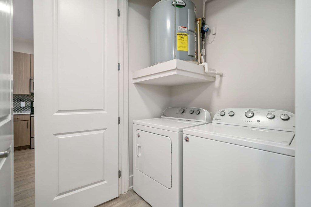 A small laundry room with a washer and dryer.