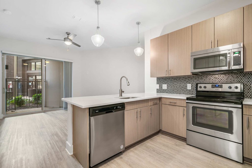 A modern kitchen with a stainless steel dishwasher and oven.