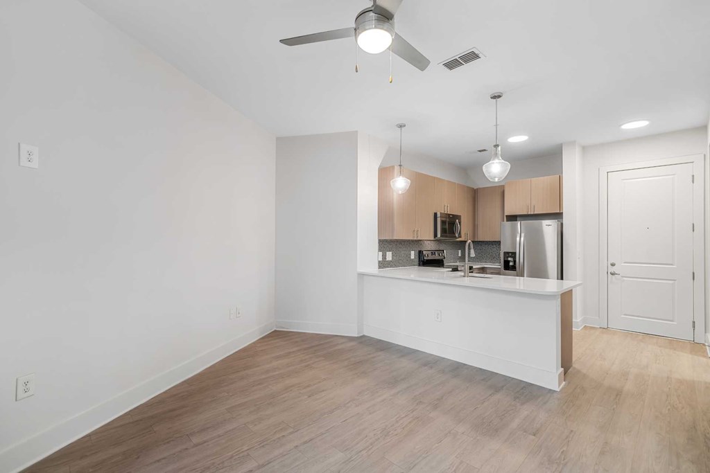 A kitchen area with a counter and cabinets.