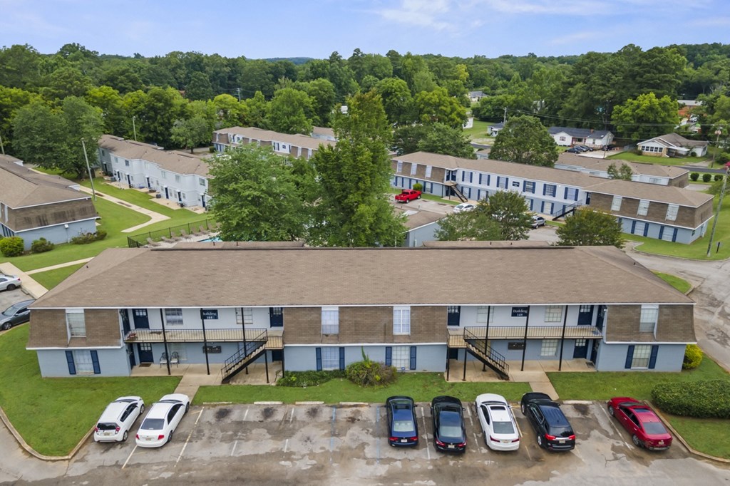an aerial view of a building with cars parked in front of it
