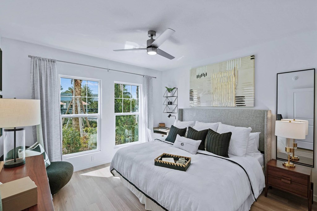 a bedroom with a large bed and a ceiling fan a bedroom with a large bed and a ceiling fan at Altis Grand Suncoast, Land O' Lakes Florida