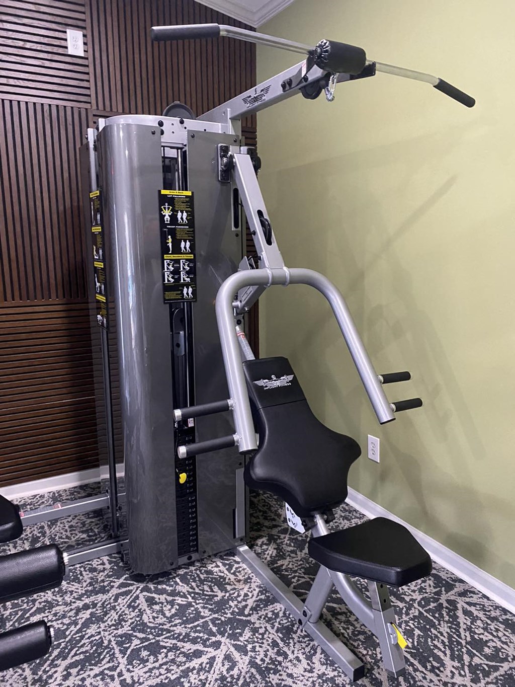 a gym with a exercise machine in the corner of a room