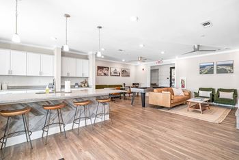 A kitchen with a bar area and a dining table.