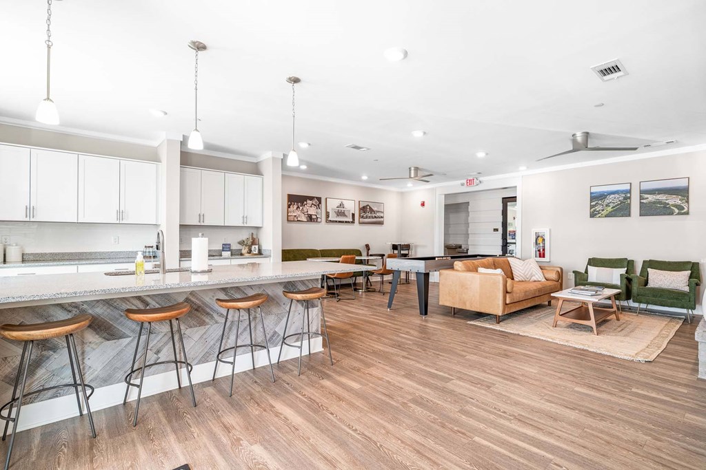 A kitchen with a bar area and a dining table.