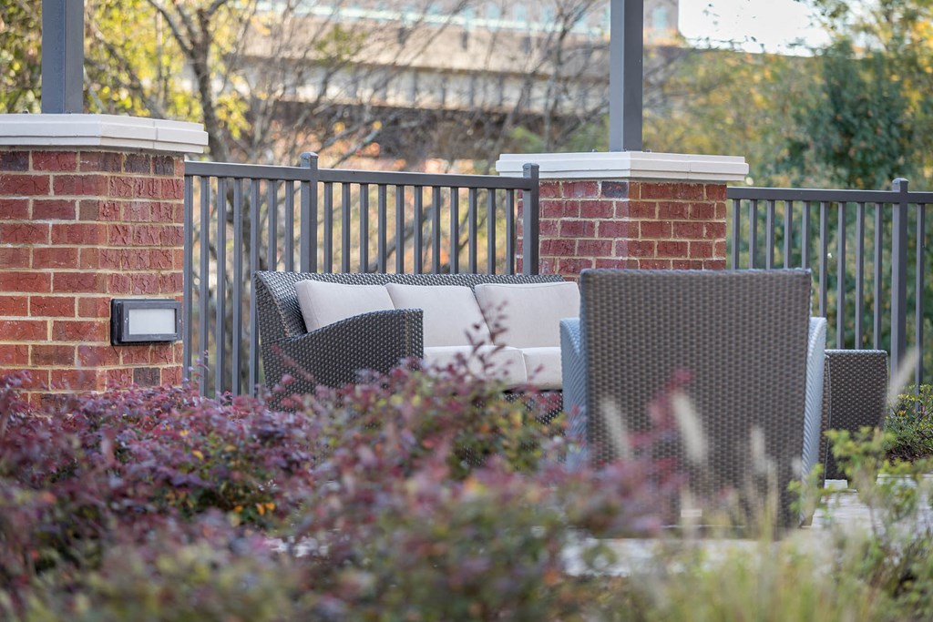 a seating area with chairs in a garden