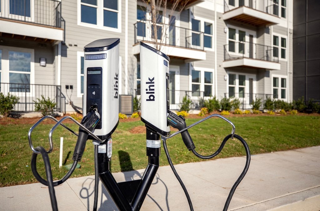 two charging stations in front of an apartment building