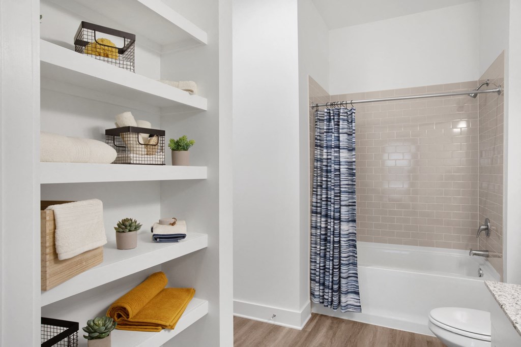 a bathroom with a shower and a toilet in a 555 waverly unit