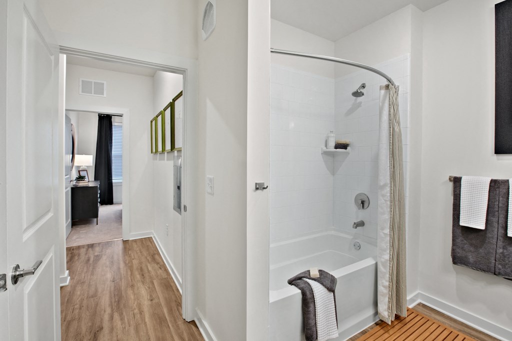 a bathroom with a shower and bathtub in a 555 waverly unit
