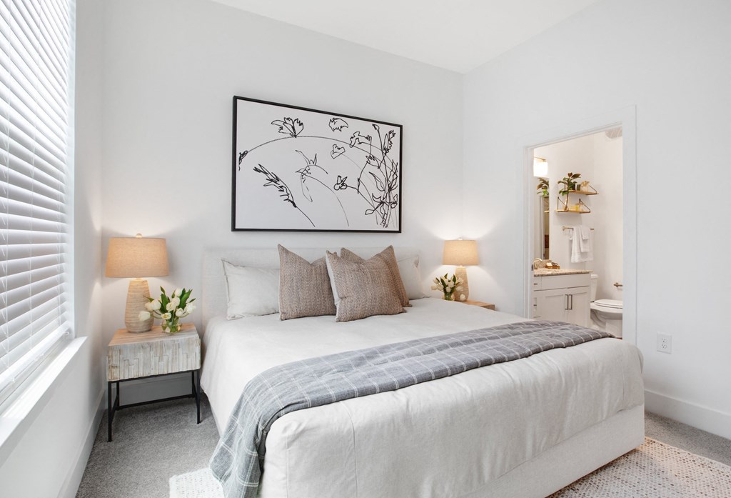 a bedroom with a bed and two night stands