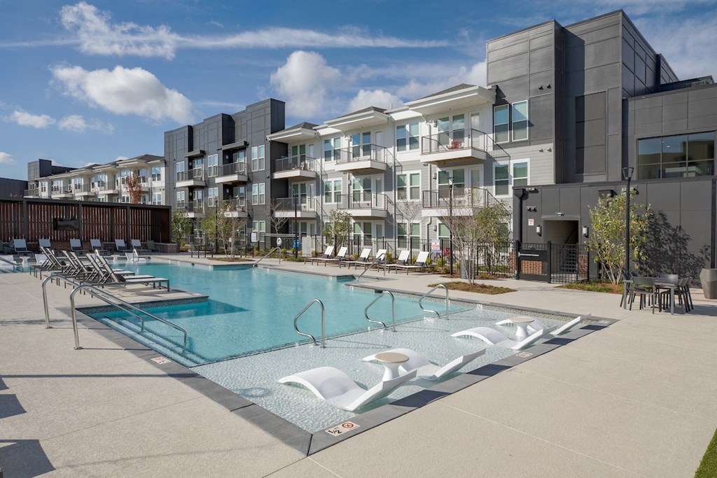 a swimming pool in front of an apartment building