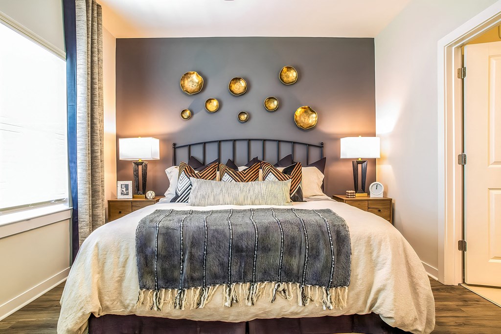 a bedroom with a large bed and gold wall decorations