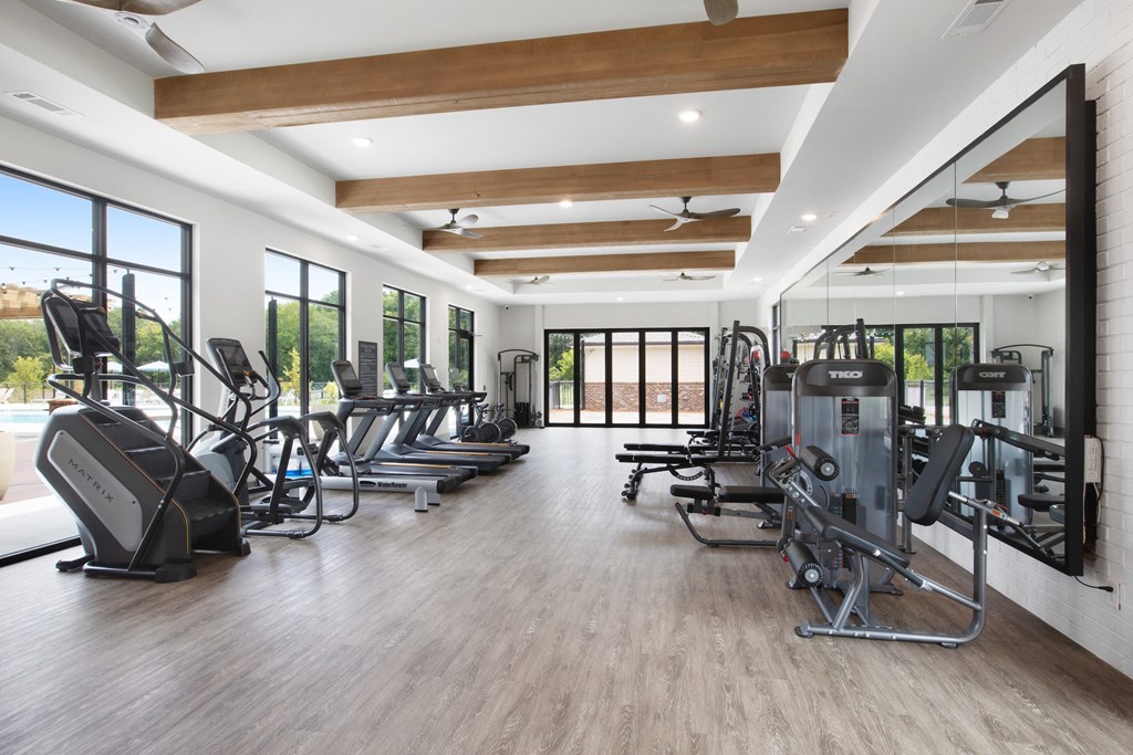 a room filled with cardio equipment and a large window