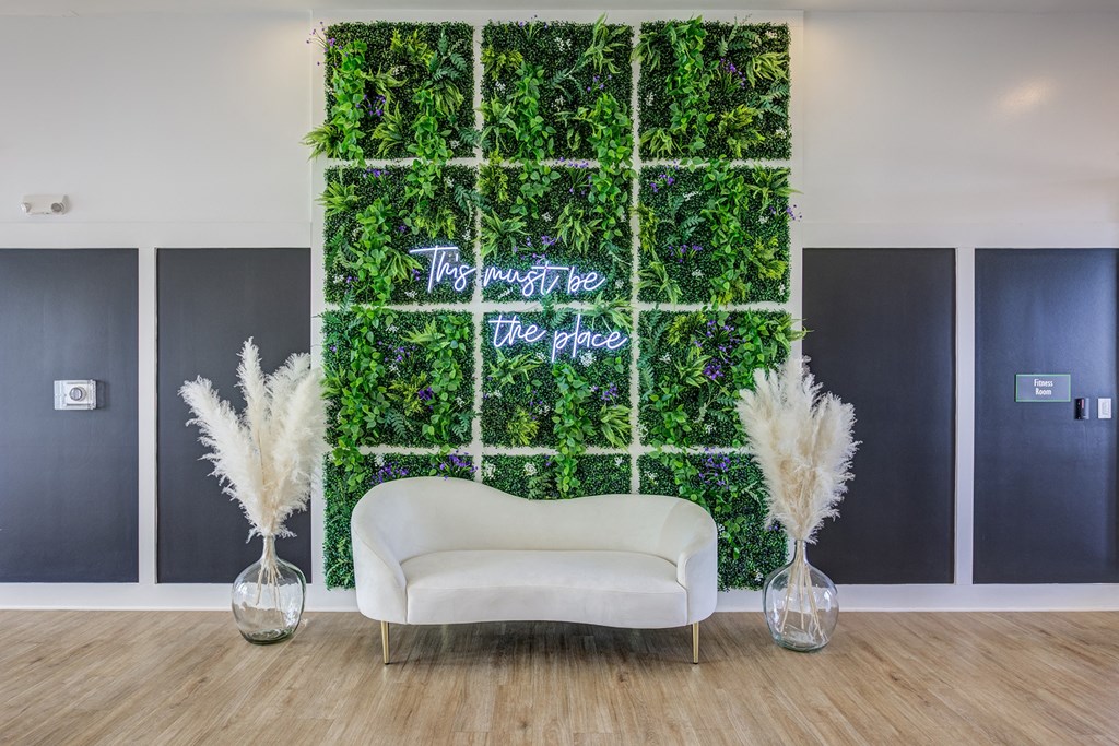 a living wall with a white couch in front of it