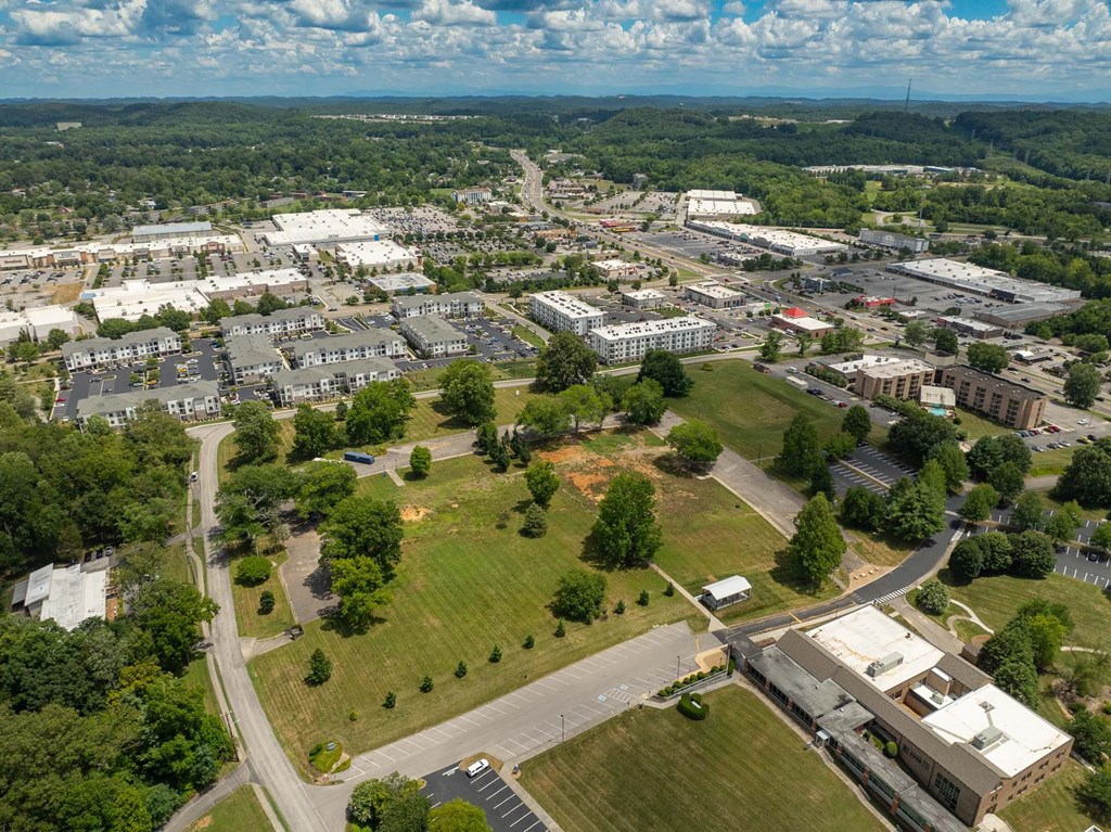 An aerial view of a town with a large building in the center.