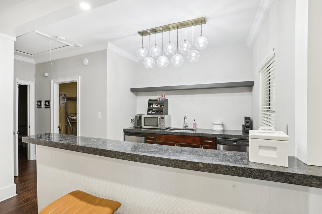 A kitchen with a marble countertop and a bench.