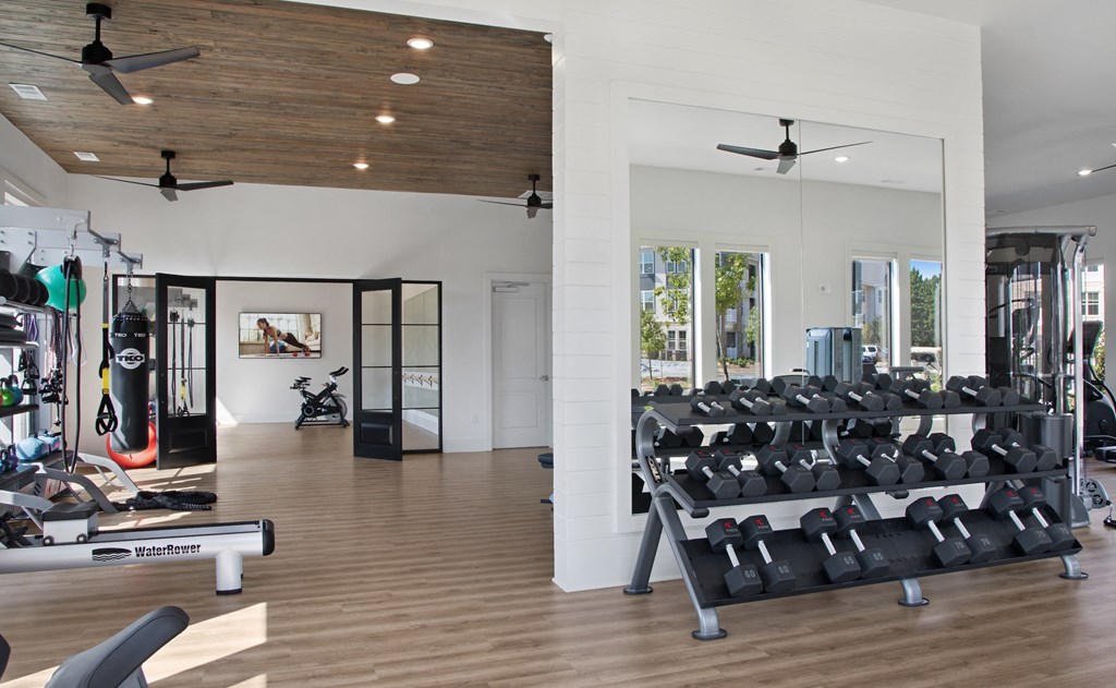 a room filled with lots of cardio equipment and weights