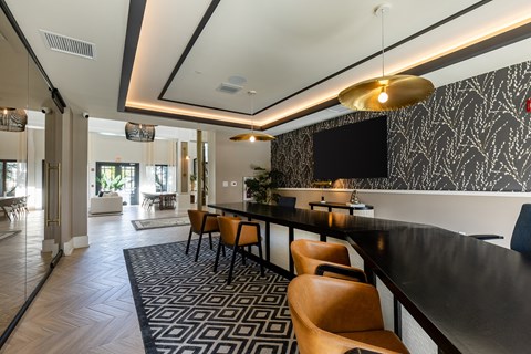 A modern dining area with a black and white patterned wallpaper.