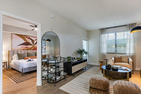 A bedroom with a large bed and a mirror on the wall.