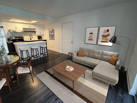 A modern living room with a grey couch and a wooden coffee table.