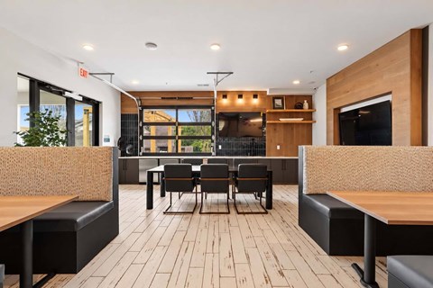 A modern dining area with wooden floors and furniture.