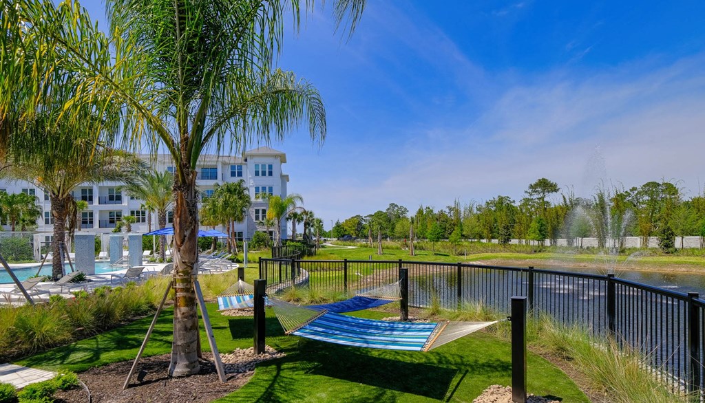 a view of a lagoon with hammocks next to a lake and a resort