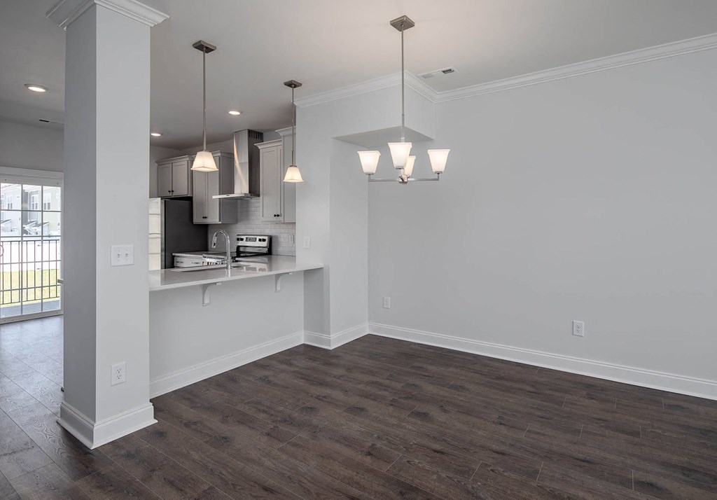 the gathering room and kitchen in the highland homes 86s model in star trail