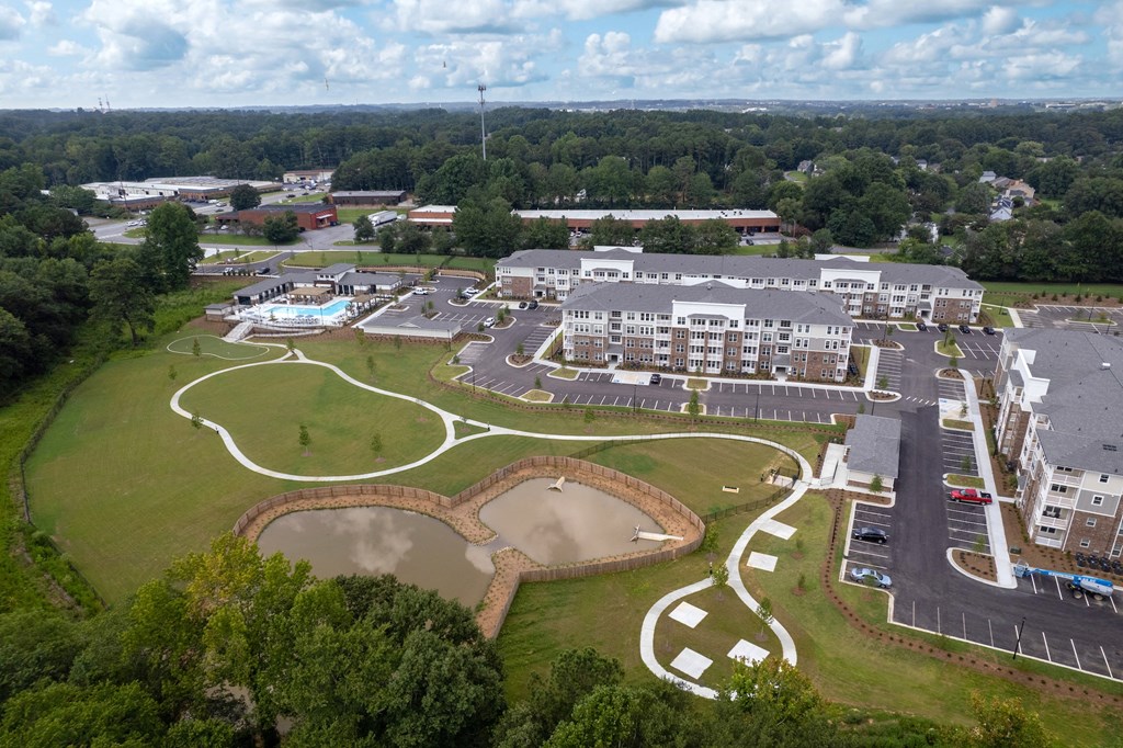 an aerial view of a building and a baseball field