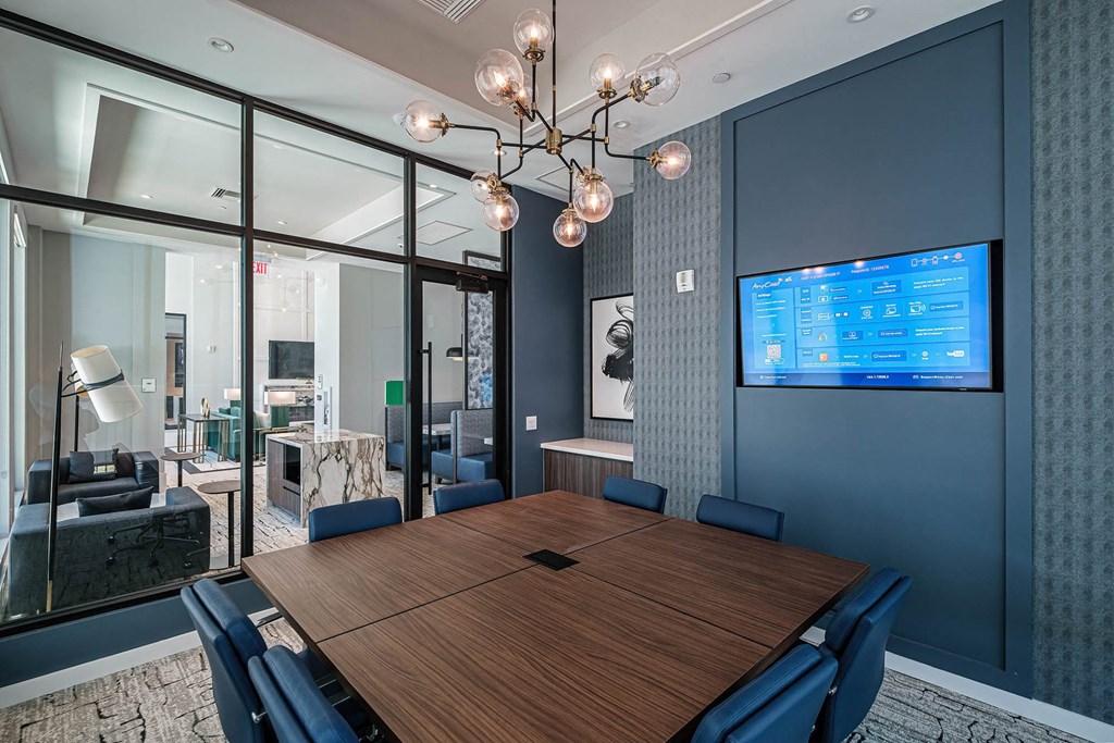 a conference room with a large conference table and a tv