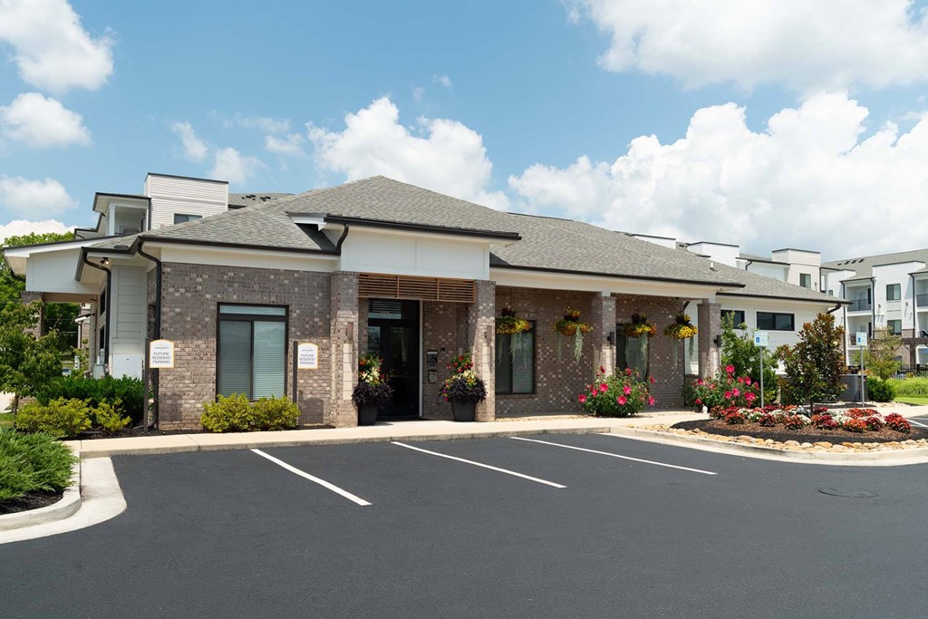 A building with a parking lot in front of it.